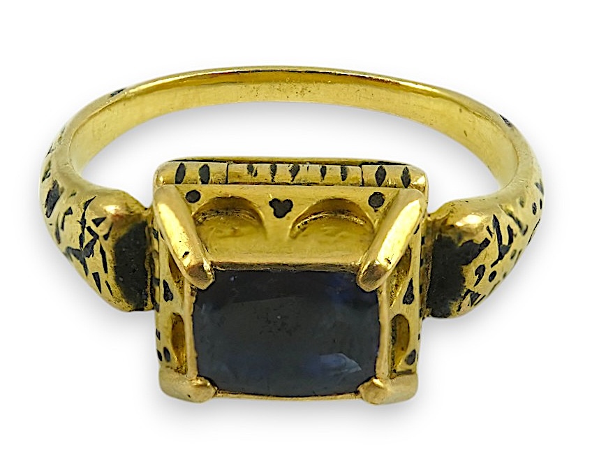 An antique high carat gold, black enamel and later? collet set cushion cut sapphire set 'poison' ring